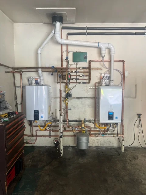 Dual tankless water heaters with copper piping, recirculation system, and control panel installation