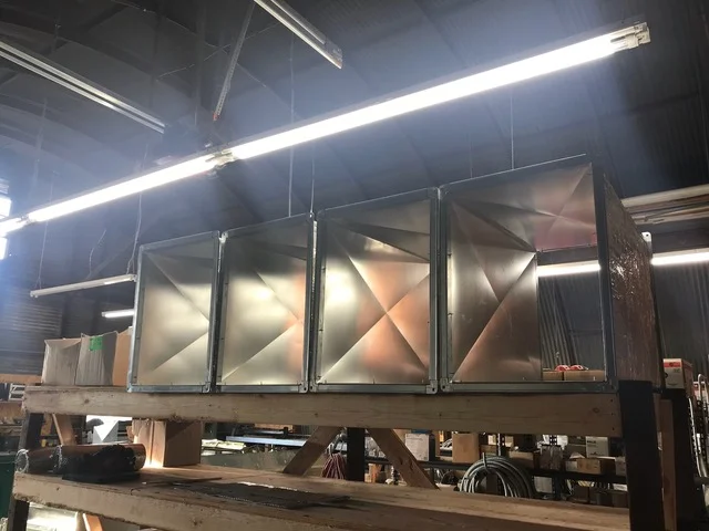 Custom sheet metal ductwork with X-bracing and insulation on steel frame with LED lighting